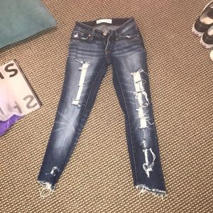 Ripped jeans with uneven ends